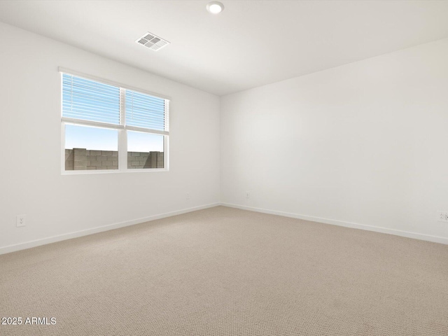 unfurnished room featuring light carpet, visible vents, and baseboards