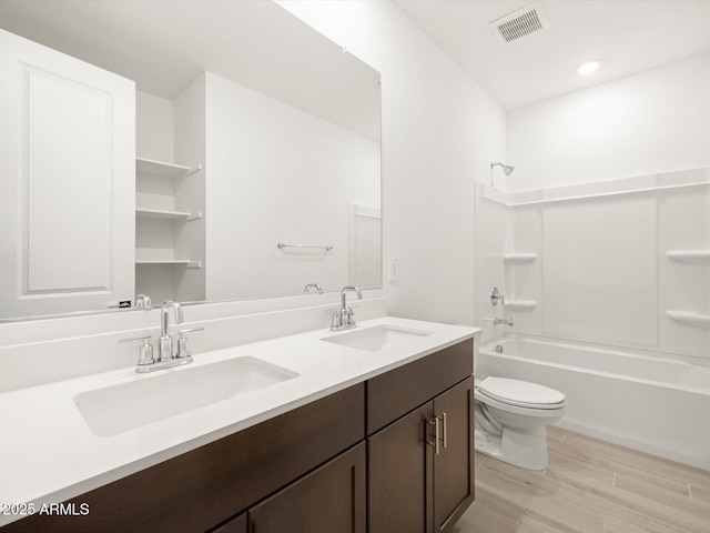 bathroom with bathing tub / shower combination, visible vents, a sink, and toilet