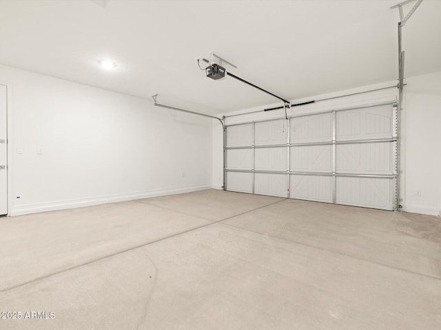 garage featuring a garage door opener and baseboards