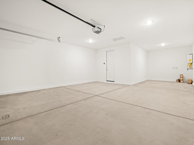 garage featuring a garage door opener and baseboards