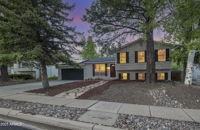 1540 N Foxglenn St, Flagstaff, AZ 86004 - tri-level home with driveway and an attached garage