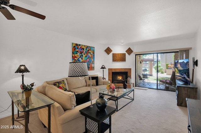 8651 E Royal Palm Rd Unit 121, Scottsdale, AZ 85258 - living area featuring a ceiling fan, a tile fireplace, and light colored carpet