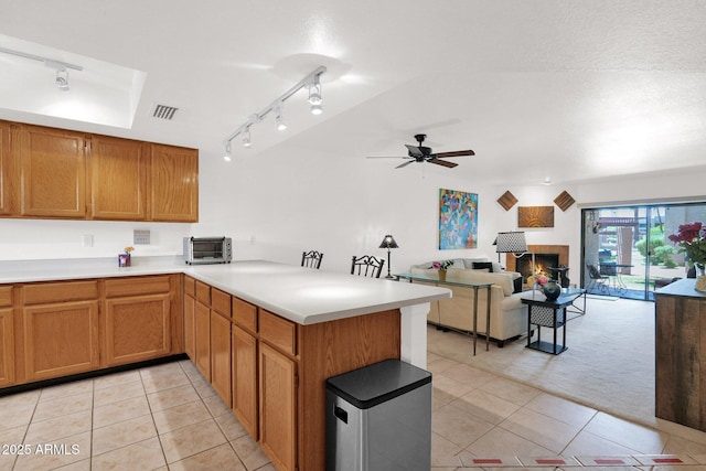 8651 E Royal Palm Rd Unit 121, Scottsdale, AZ 85258 - kitchen with a peninsula, rail lighting, and light tile patterned floors