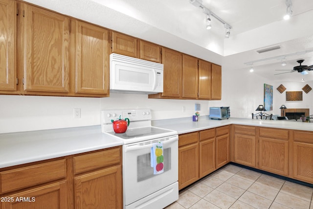8651 E Royal Palm Rd Unit 121, Scottsdale, AZ 85258 - kitchen featuring white appliances, track lighting, light tile patterned floors, light countertops, and ceiling fan