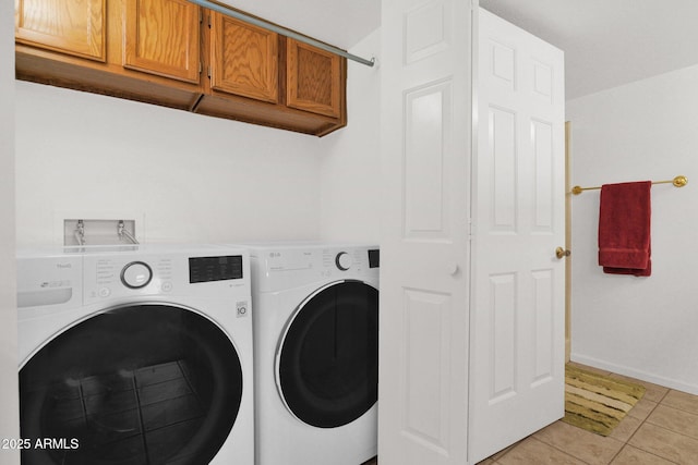 8651 E Royal Palm Rd Unit 121, Scottsdale, AZ 85258 - washroom featuring cabinet space, separate washer and dryer, and light tile patterned floors
