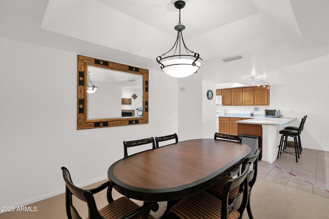 8651 E Royal Palm Rd Unit 121, Scottsdale, AZ 85258 - dining area with light tile patterned floors and a tray ceiling