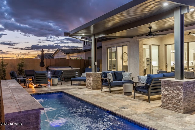 view of swimming pool with ceiling fan, a hot tub, outdoor lounge area, a patio area, and fence