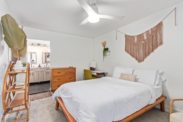 bedroom with a sink, ceiling fan, and ensuite bath