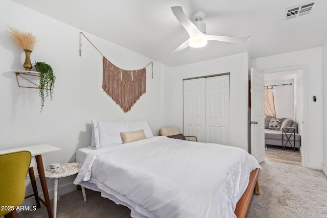bedroom with visible vents, a closet, carpet, and a ceiling fan