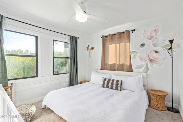 carpeted bedroom featuring baseboards and ceiling fan
