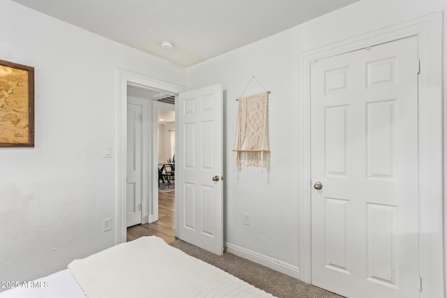 bedroom with baseboards and carpet floors