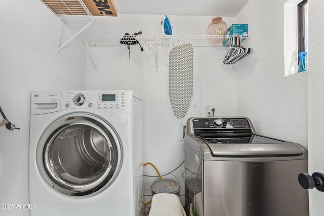 washroom featuring washer and clothes dryer and laundry area