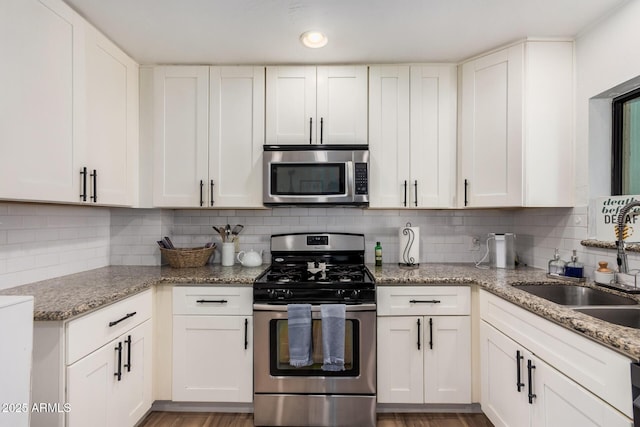 kitchen featuring white cabinets, a sink, and appliances with stainless steel finishes