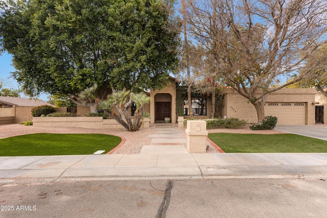 view of front of house featuring a front yard and a garage