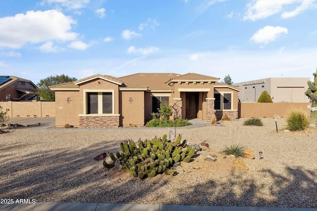 28431 N Rambling Rock Ct, Wittmann, AZ 85361 - view of front of home featuring stucco siding, fence, a tile roof, and stone siding