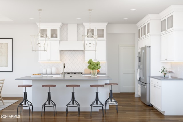 kitchen with decorative light fixtures, white cabinetry, and custom range hood