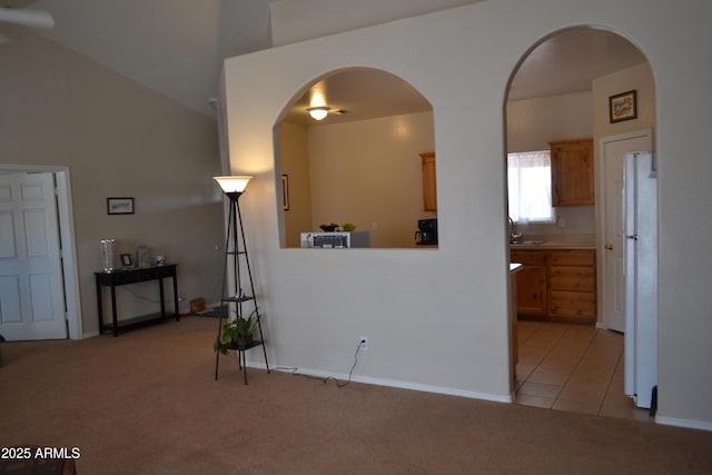 2740 E Walnut Dr, Show Low, AZ 85901 - unfurnished room featuring light colored carpet, arched walkways, a sink, a towering ceiling, and a ceiling fan