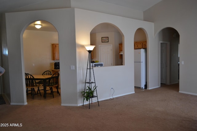 2740 E Walnut Dr, Show Low, AZ 85901 - living area with light colored carpet, baseboards, and arched walkways