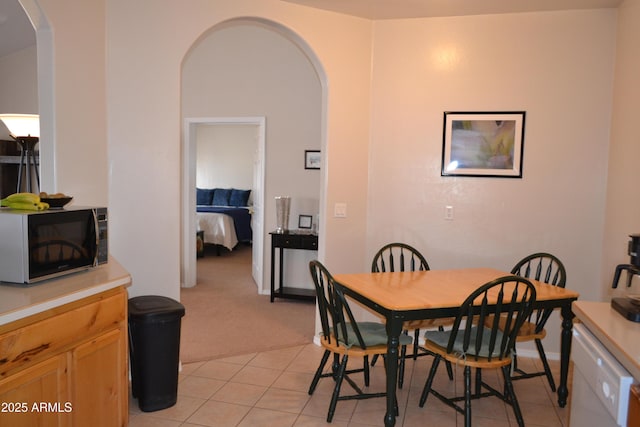 2740 E Walnut Dr, Show Low, AZ 85901 - dining room with arched walkways, light carpet, and light tile patterned floors