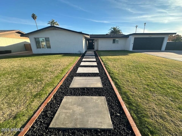 ranch-style home with a garage and a front lawn