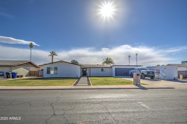 view of front of property with a garage and a front lawn