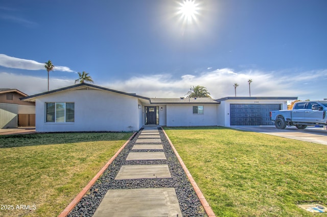 ranch-style house featuring a garage and a front yard