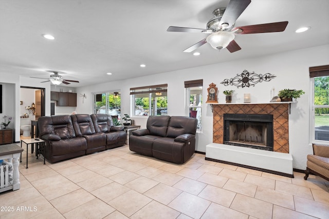 10532 W Catalina Dr, Avondale, AZ 85392 - living room with a ceiling fan, recessed lighting, a fireplace with raised hearth, and light tile patterned flooring