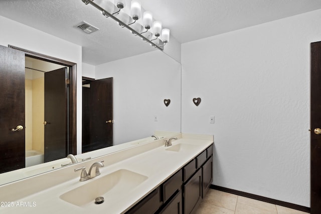 10532 W Catalina Dr, Avondale, AZ 85392 - full bathroom featuring baseboards, double vanity, tile patterned flooring, and a textured ceiling