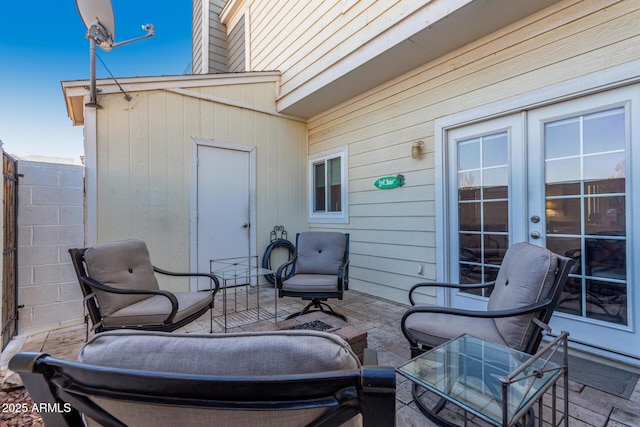 view of patio / terrace featuring french doors and fence