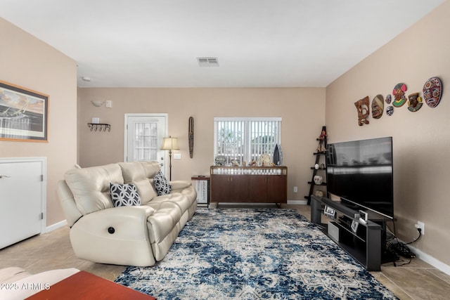 living room with visible vents and baseboards