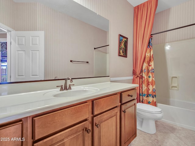 bathroom featuring toilet, tile patterned floors, vanity, and wallpapered walls