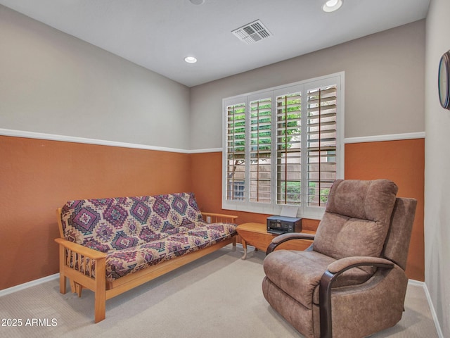 carpeted living room with visible vents, baseboards, and recessed lighting