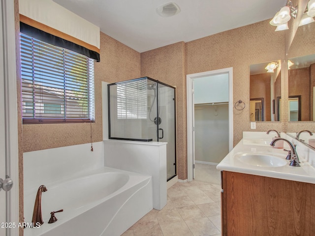 full bathroom with a sink, tile patterned floors, a shower stall, double vanity, and a garden tub