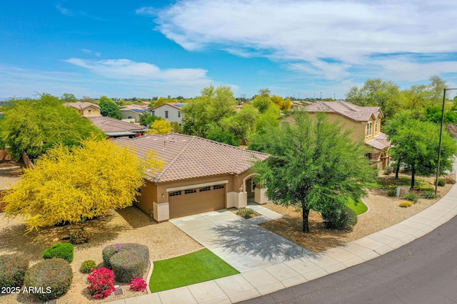 view of front of property featuring a residential view, driveway, a garage, stucco siding, and a tiled roof