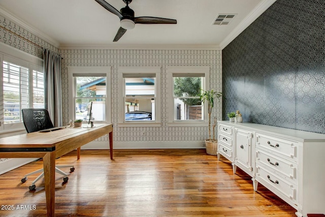 unfurnished office with visible vents, wallpapered walls, crown molding, and light wood-type flooring