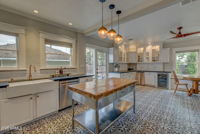 kitchen with beverage cooler, ornamental molding, a sink, backsplash, and stainless steel dishwasher