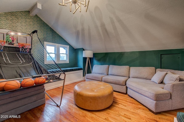 living area with lofted ceiling with beams and wood finished floors