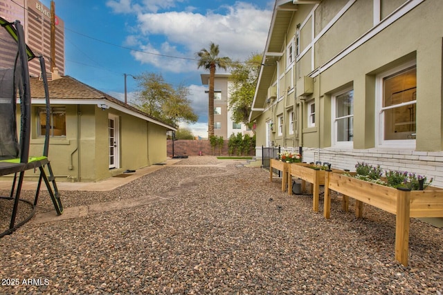 exterior space featuring fence and stucco siding