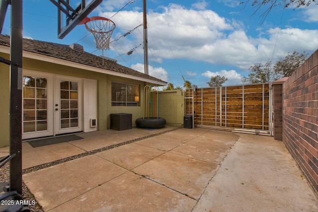 view of patio / terrace featuring french doors, fence, and a gate