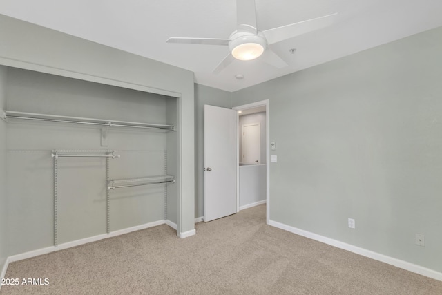 unfurnished bedroom with baseboards, a ceiling fan, a closet, and carpet flooring