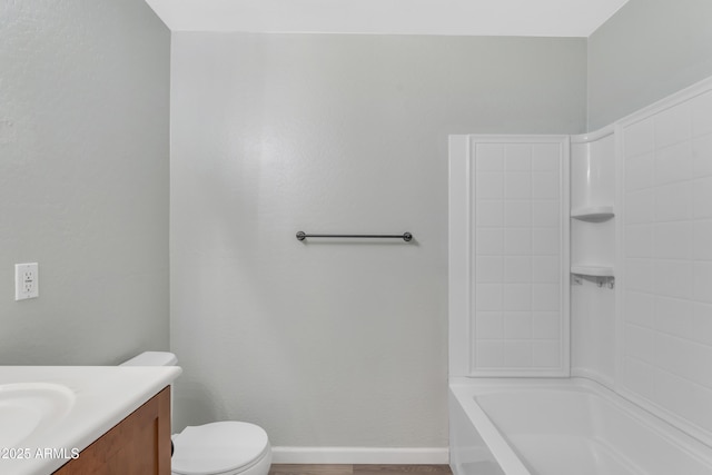 full bath featuring vanity, baseboards, and toilet
