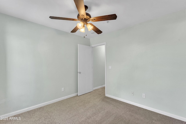 unfurnished room with a ceiling fan, baseboards, and light colored carpet