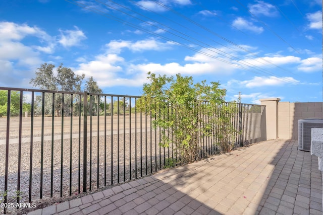 view of patio / terrace with fence and central AC unit