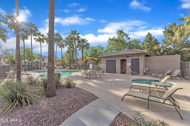 community pool featuring fence and a patio area