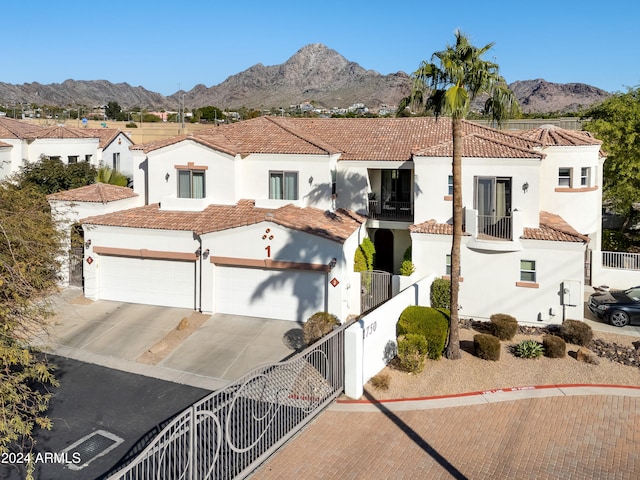 mediterranean / spanish home with a mountain view and a garage