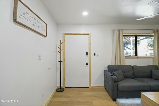 foyer with recessed lighting, baseboards, and light wood-style floors