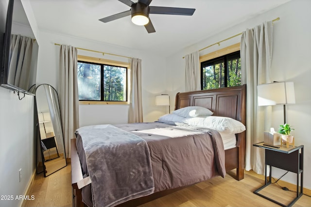 bedroom with ceiling fan and light wood-type flooring