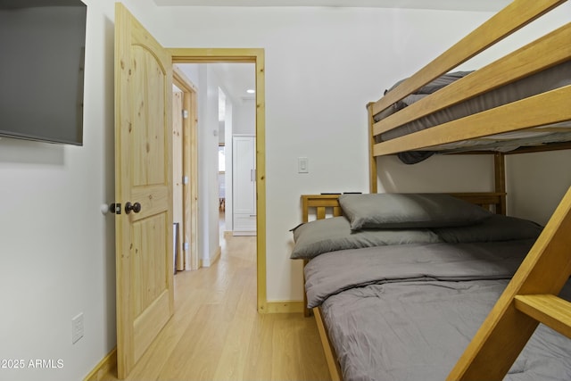 bedroom with baseboards and wood finished floors