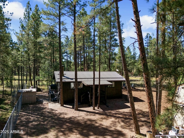 exterior space with an outbuilding and metal roof