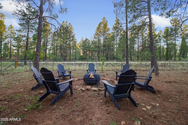 view of yard featuring fence and a fire pit